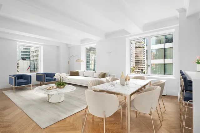 a kitchen with granite countertop a white stove top oven cabinets and a dining table