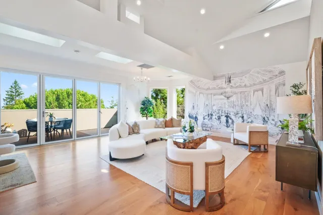 a living room with furniture and a chandelier