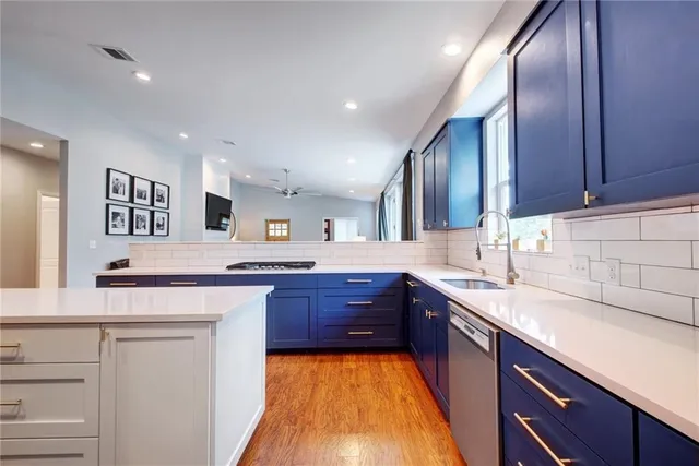 a large kitchen with stainless steel appliances granite countertop a sink stove and refrigerator