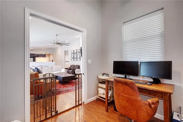 a view of a workspace with furniture and a window