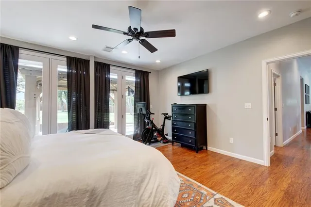 a bedroom with a bed and a flat tv screen