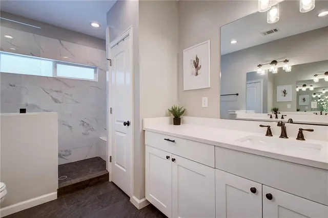 a bathroom with a double vanity sink and mirror