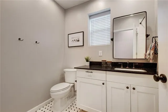 a bathroom with a toilet sink and mirror