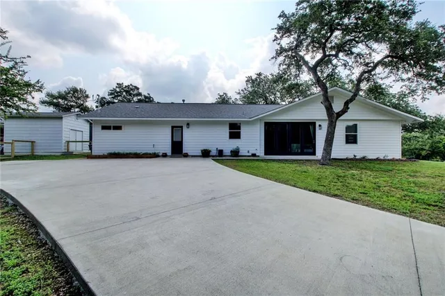 a front view of house with yard and green space