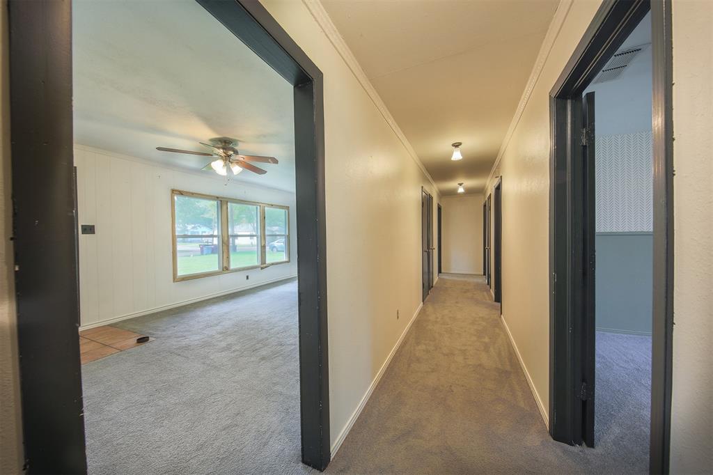 1004 Pecan Street Canton, TX 75103 - Photo 11 of 21 a view of a hallway with wooden floor and chandelier