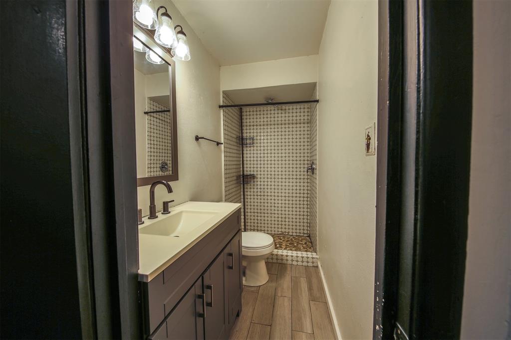 1004 Pecan Street Canton, TX 75103 - Photo 12 of 21 a bathroom with a sink a toilet a mirror and shower
