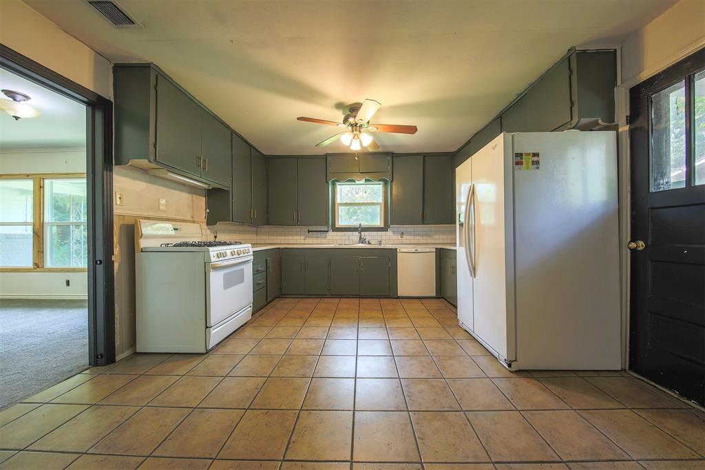 1004 Pecan Street Canton, TX 75103 - Photo 7 of 21 a kitchen with stainless steel appliances granite countertop a refrigerator and a sink