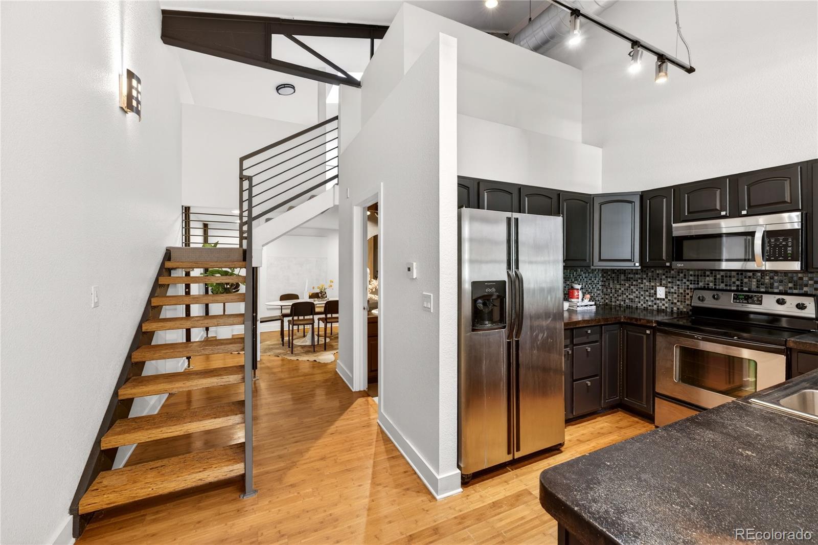 1421 Oneida Street, Unit 7 Denver, CO 80220 - Photo 13 of 22 a kitchen with stainless steel appliances granite countertop a refrigerator and a stove top oven