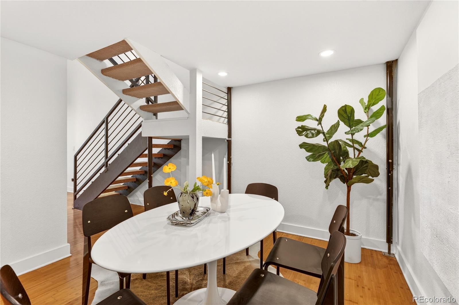 1421 Oneida Street, Unit 7 Denver, CO 80220 - Photo 14 of 22 a view of a dining room with furniture and wooden floor