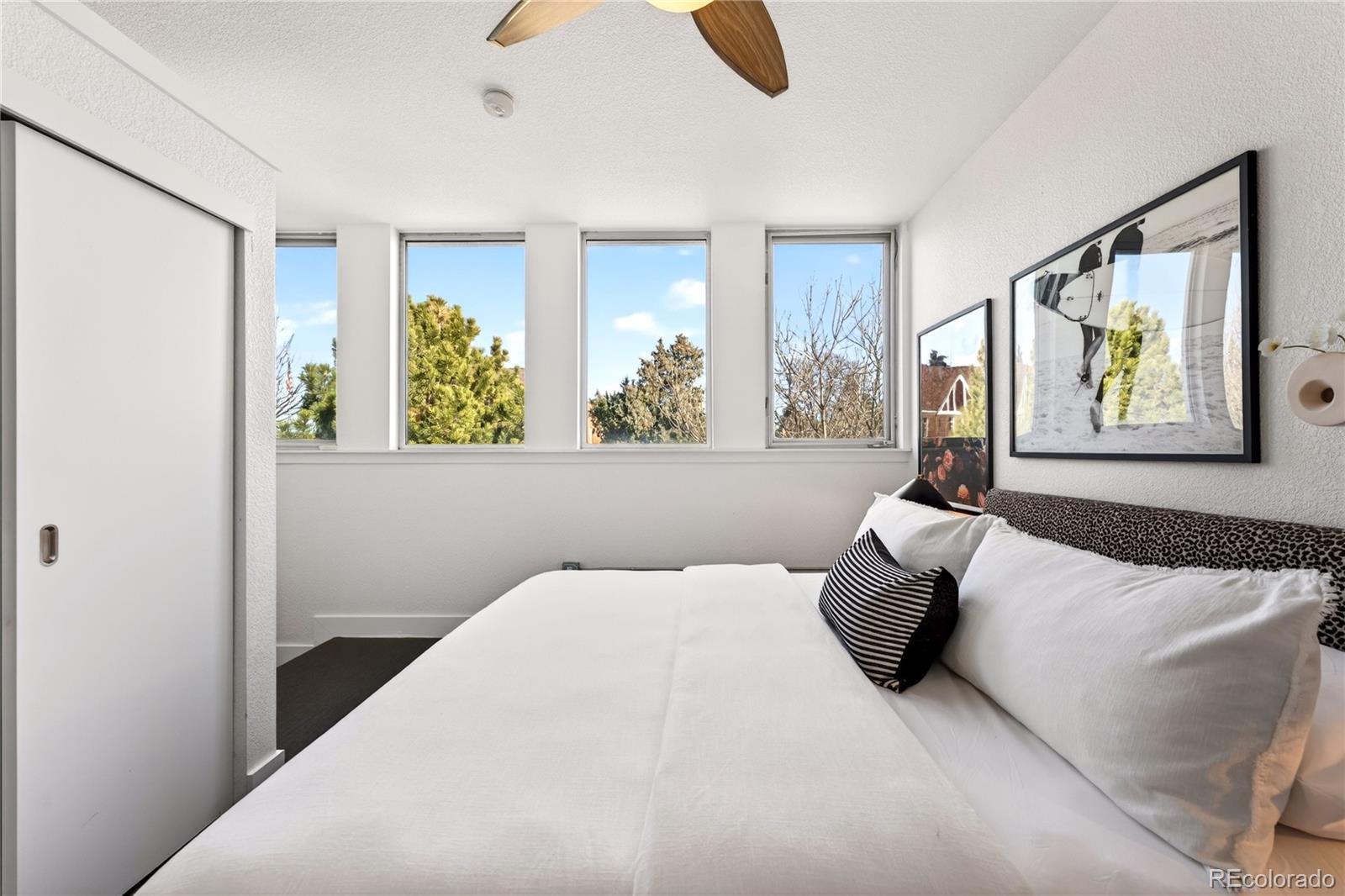 1421 Oneida Street, Unit 7 Denver, CO 80220 - Photo 4 of 22 a bed sitting in a bedroom next to a window