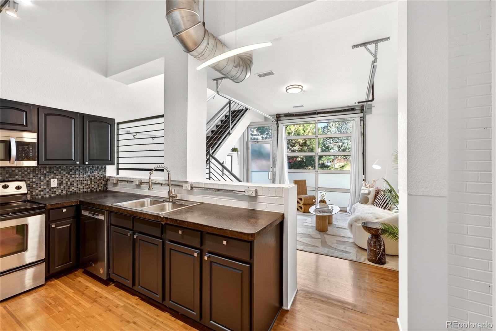 1421 Oneida Street, Unit 7 Denver, CO 80220 - Photo 5 of 22 a kitchen with a sink stove and cabinets