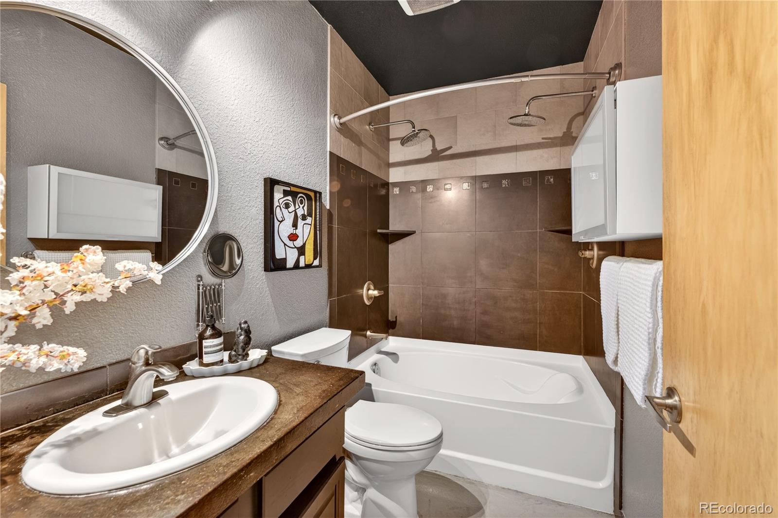 1421 Oneida Street, Unit 7 Denver, CO 80220 - Photo 6 of 22 a bathroom with a sink a toilet and shower