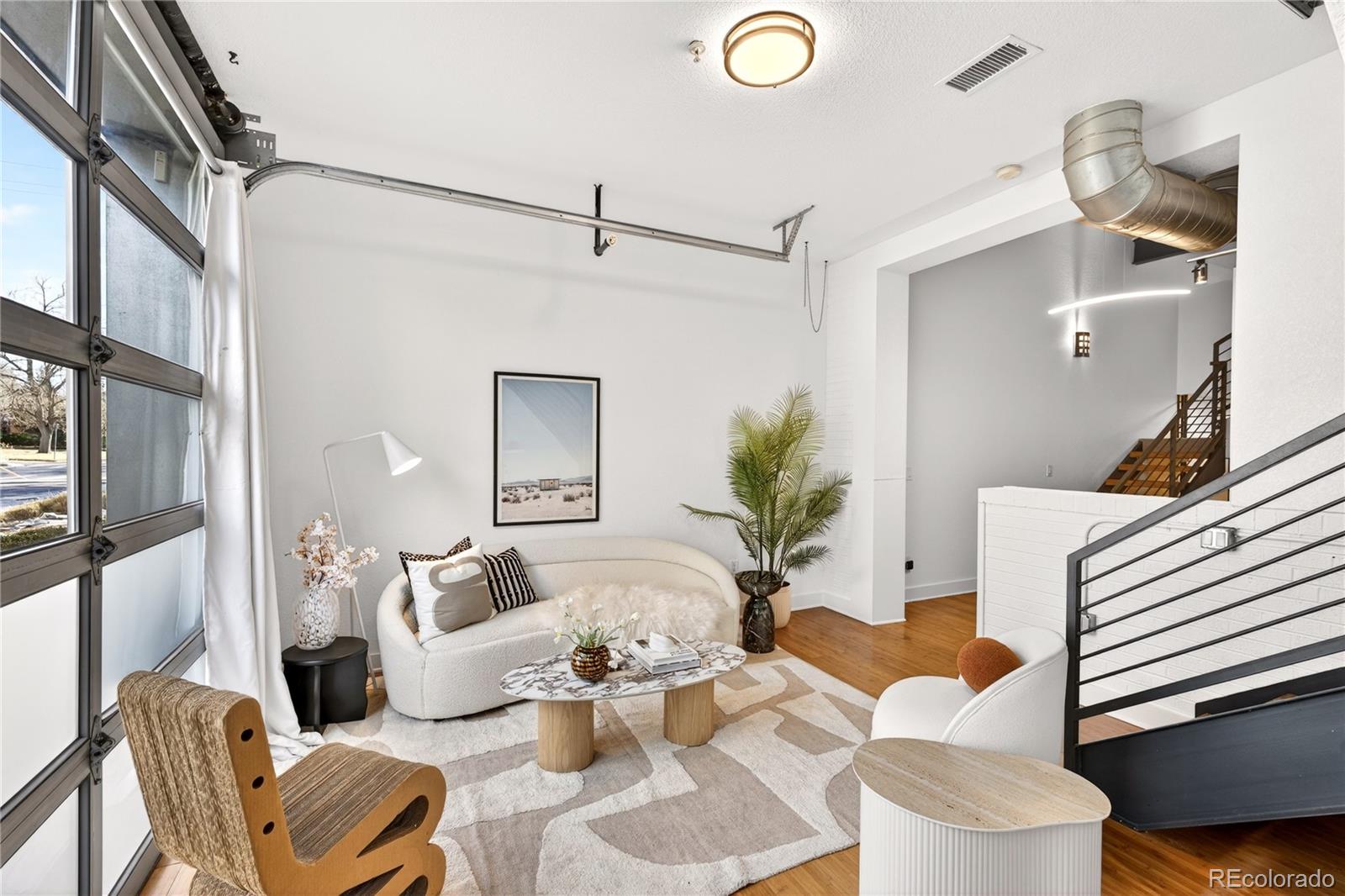 1421 Oneida Street, Unit 7 Denver, CO 80220 - Photo 7 of 22 a living room with furniture and a painting on the wall
