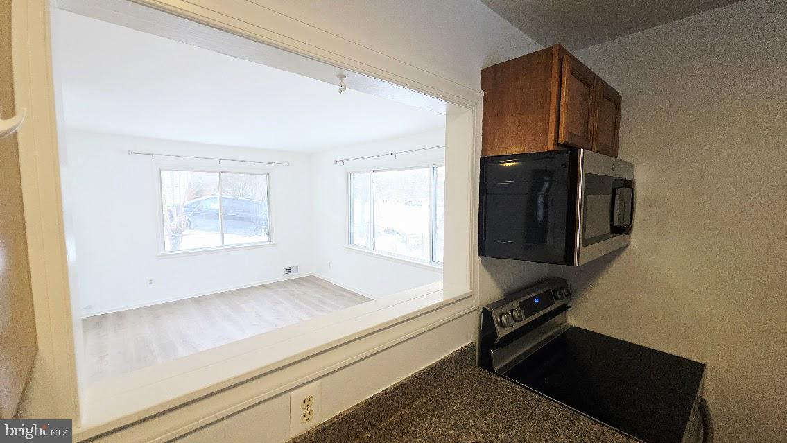 12217 Valleywood Drive Silver Spring, MD 20902 - Photo 12 of 36 a kitchen with a refrigerator and a stove top oven
