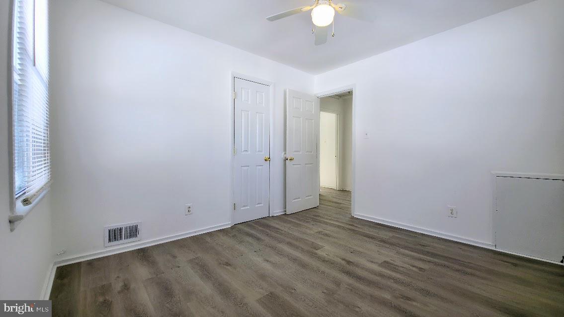 12217 Valleywood Drive Silver Spring, MD 20902 - Photo 22 of 36 an empty room with wooden floor and windows