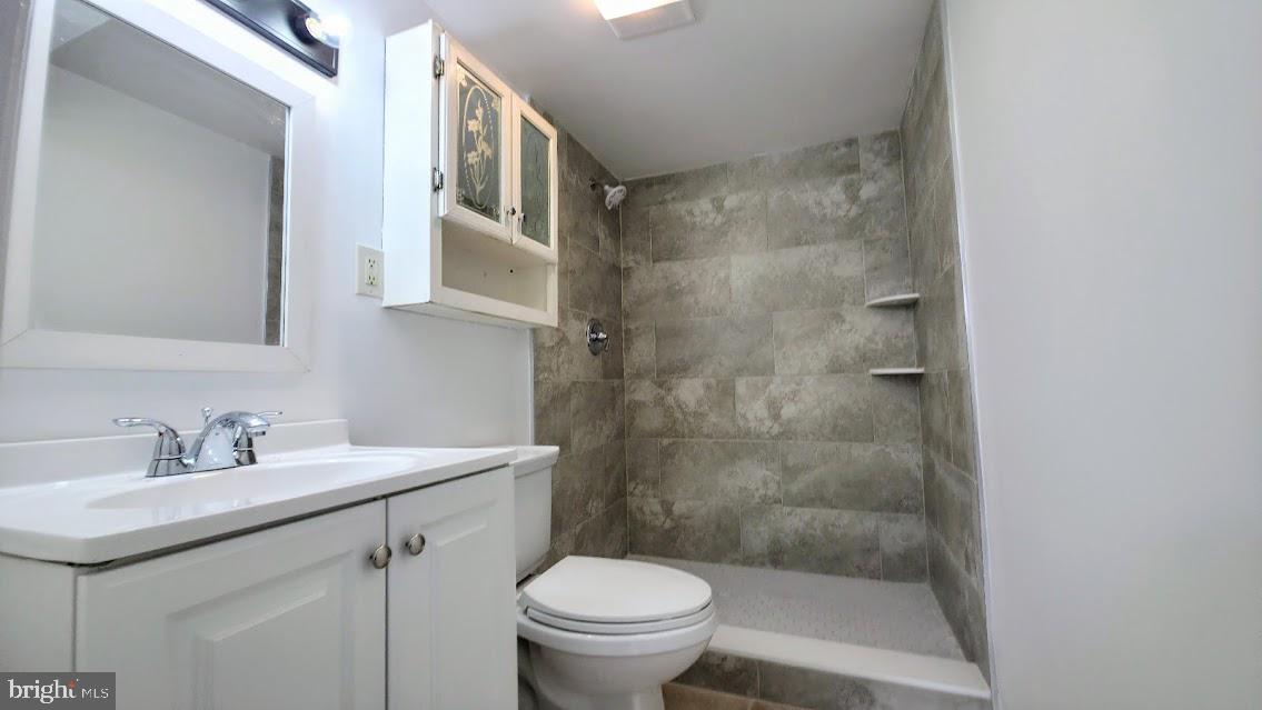 12217 Valleywood Drive Silver Spring, MD 20902 - Photo 30 of 36 a bathroom with a sink a toilet and a mirror