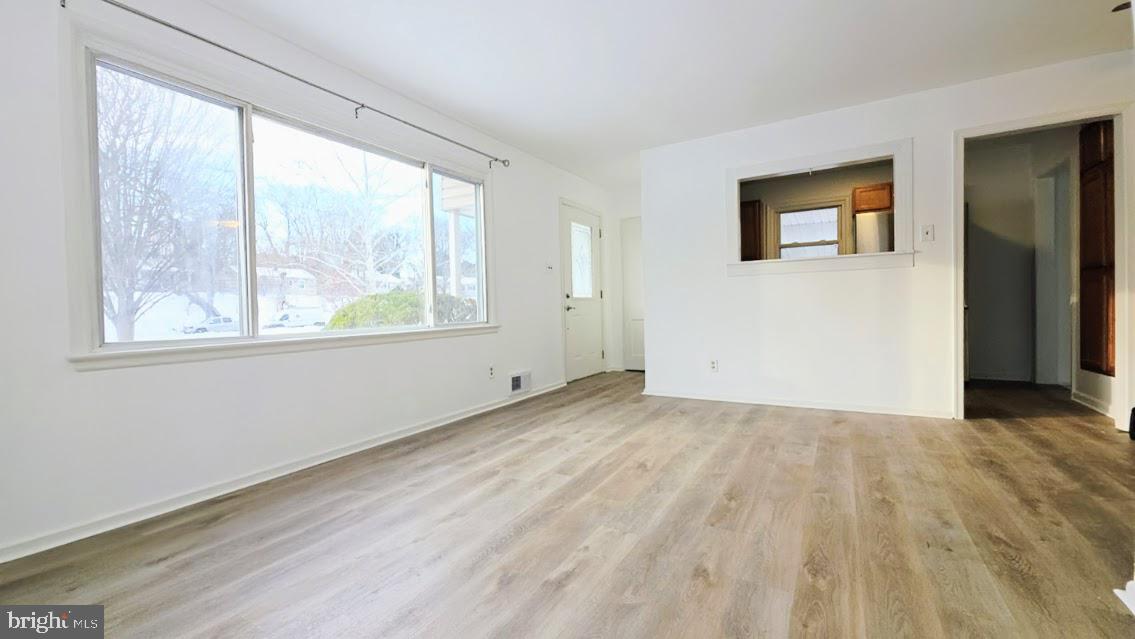 12217 Valleywood Drive Silver Spring, MD 20902 - Photo 3 of 36 a view of an empty room with wooden floor and a window