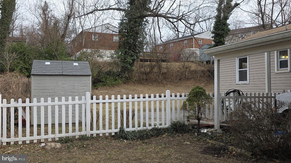 12217 Valleywood Drive Silver Spring, MD 20902 - Photo 32 of 36 a front view of a house with a garden