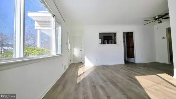 a view of a bedroom with wooden floor and front door