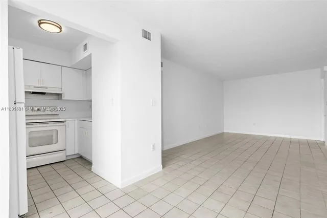 a kitchen with white cabinets and white appliances