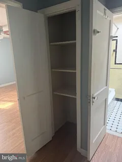 a view of walk in closet with empty room