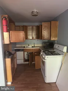 a kitchen with a stove and a refrigerator