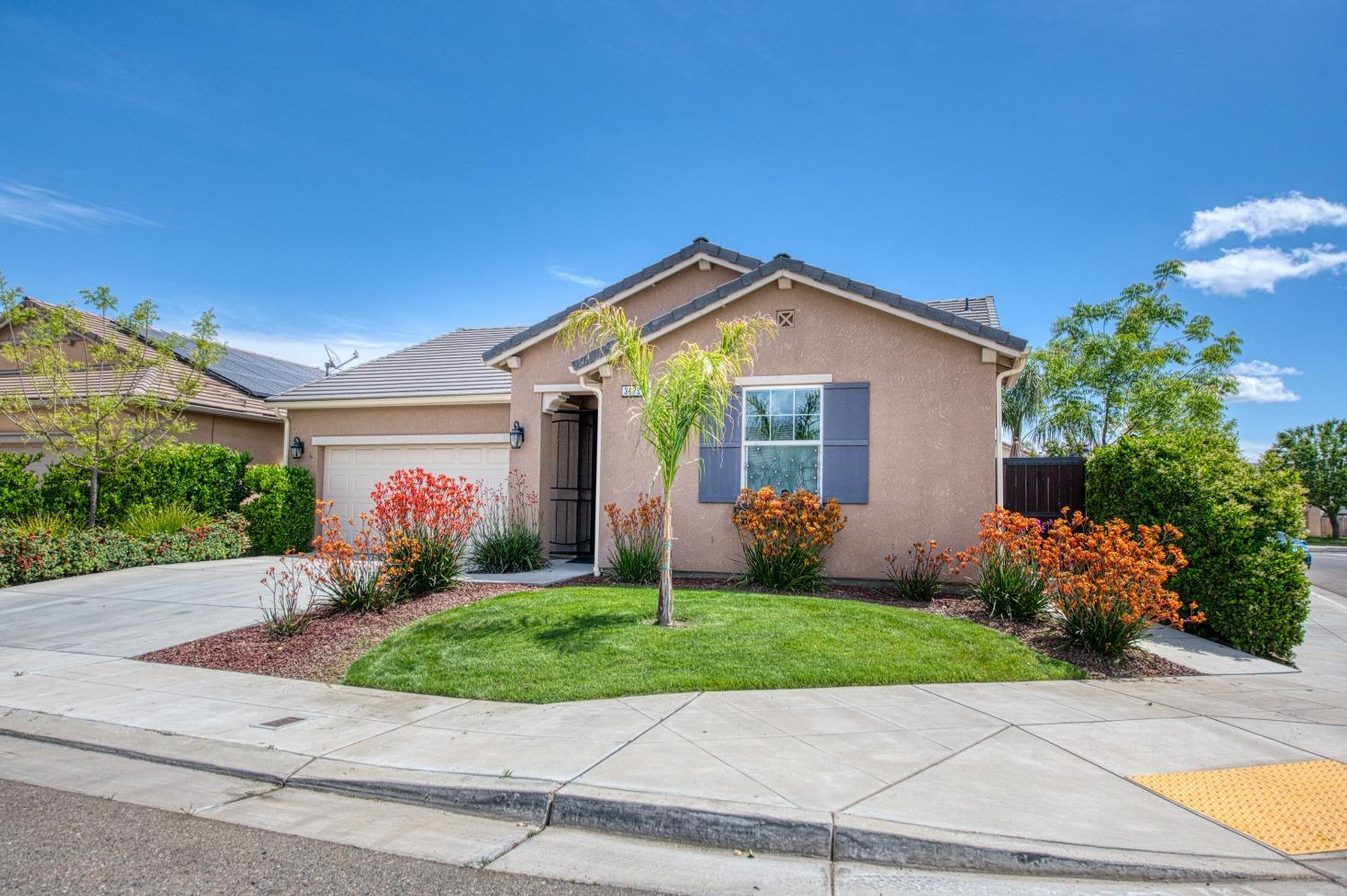 3479 Park Avenue Clovis, CA 93611 - Photo 27 of 27 a front view of a house with a yard and potted plants