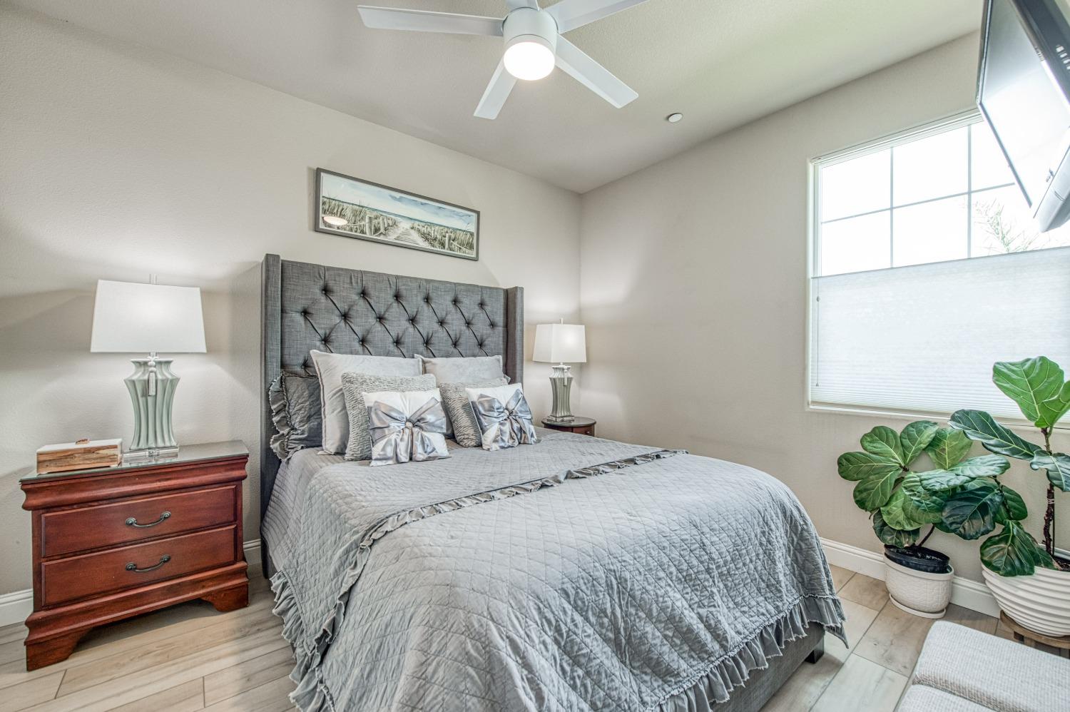 3479 Park Avenue Clovis, CA 93611 - Photo 5 of 27 a bedroom with a bed and a potted plant