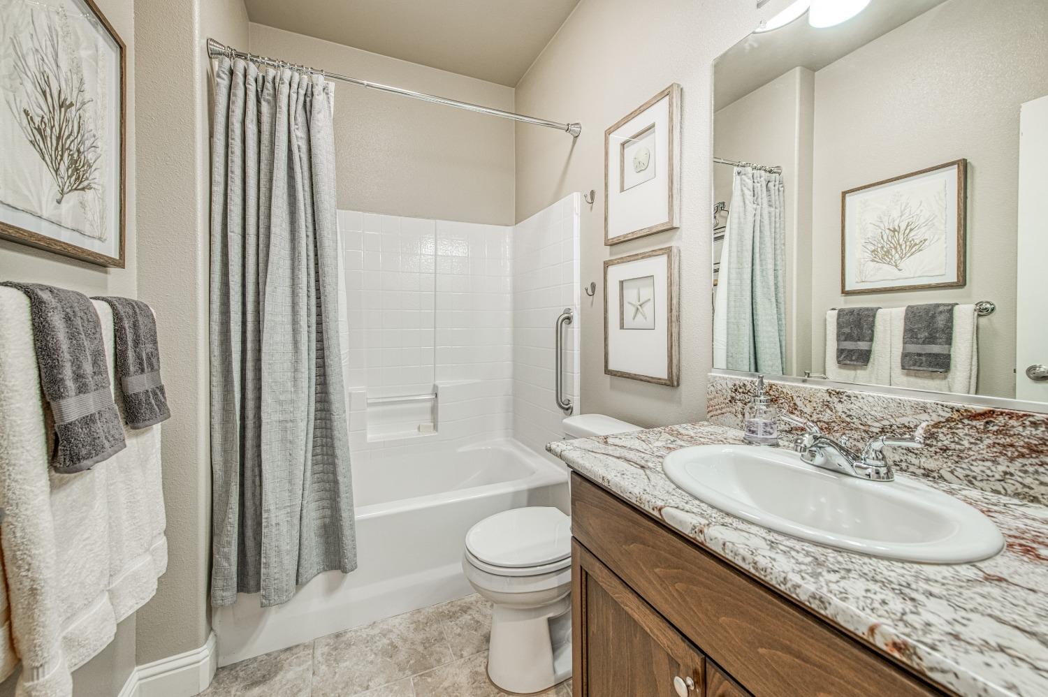 3479 Park Avenue Clovis, CA 93611 - Photo 6 of 27 a bathroom with a granite countertop sink toilet and shower