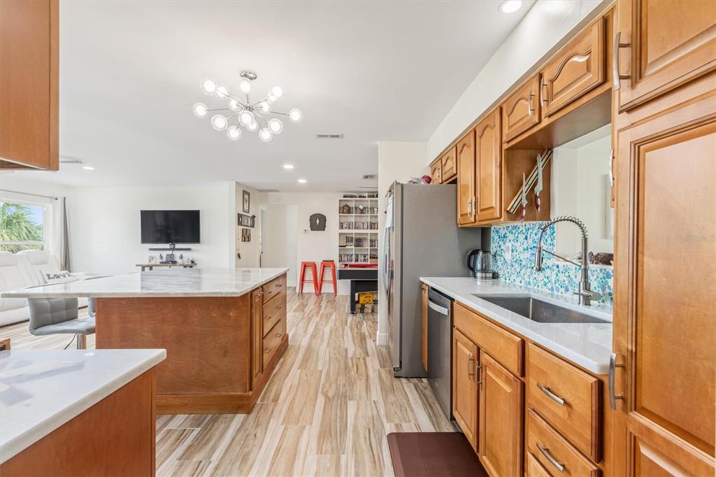 5 Cheyenne Court Palm Coast, FL 32137 - Photo 15 of 61 a large kitchen with stainless steel appliances kitchen island granite countertop a large island in the center