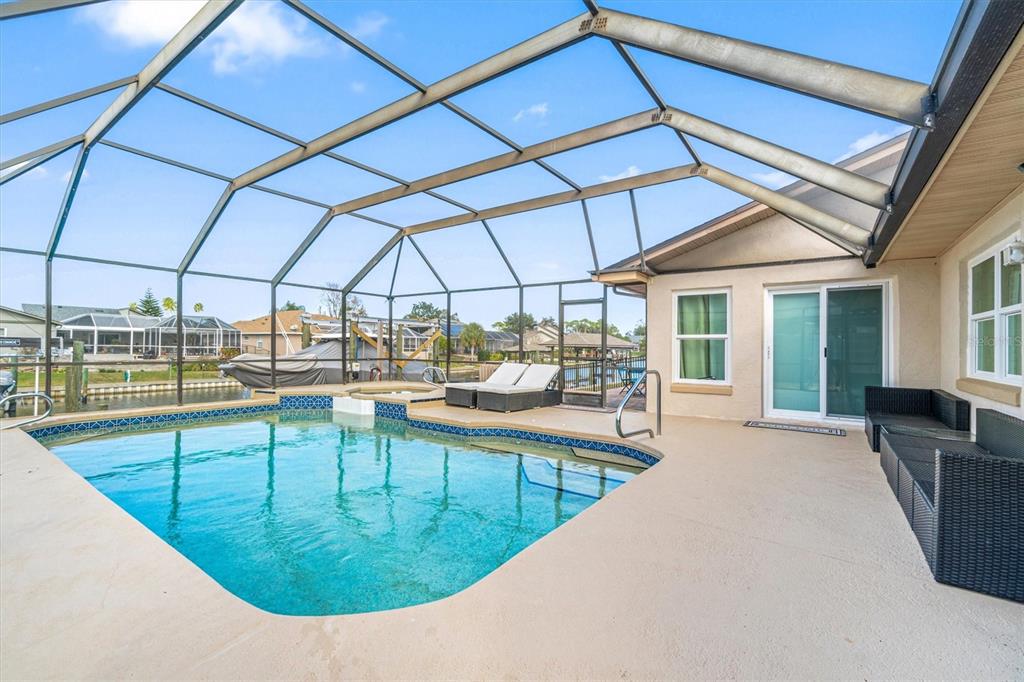 5 Cheyenne Court Palm Coast, FL 32137 - Photo 2 of 61 a view of a swimming pool with outdoor seating
