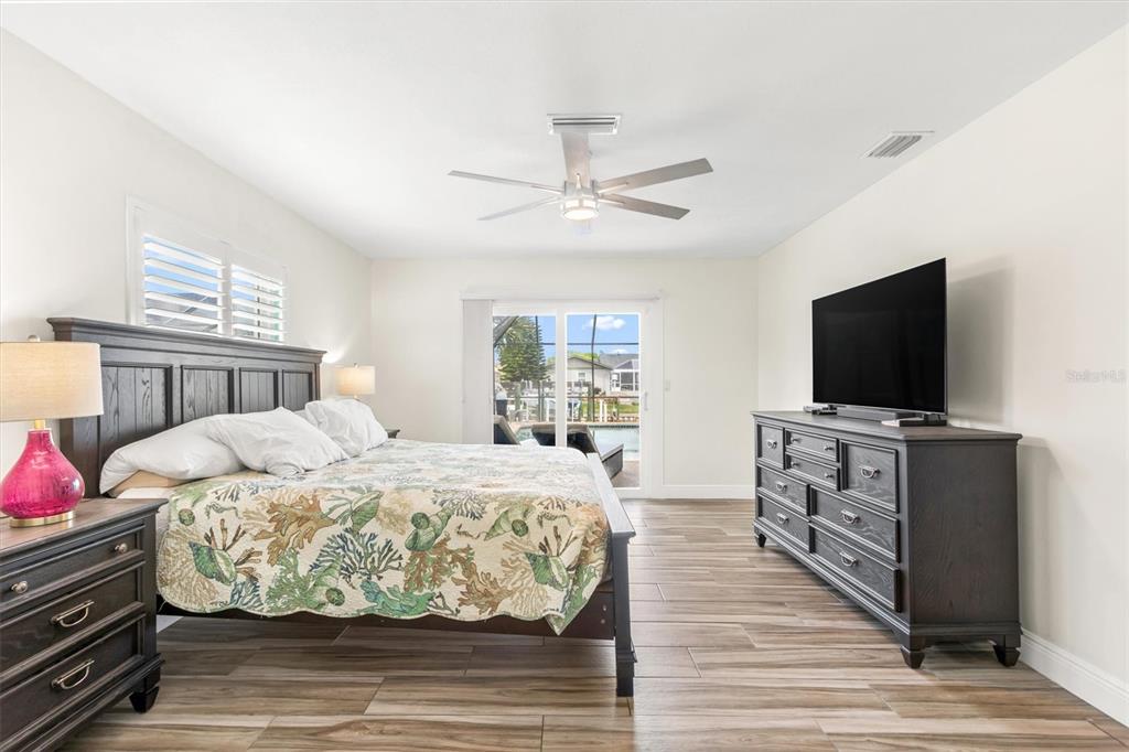 5 Cheyenne Court Palm Coast, FL 32137 - Photo 25 of 61 a bedroom with a bed and a flat screen tv