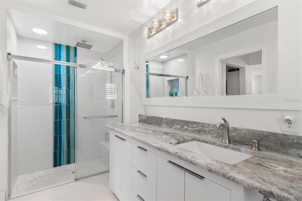 5 Cheyenne Court Palm Coast, FL 32137 - Photo 28 of 61 a bathroom with a granite countertop sink and a mirror