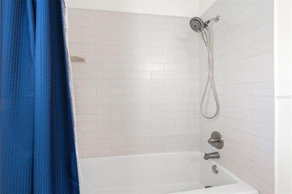 5 Cheyenne Court Palm Coast, FL 32137 - Photo 31 of 61 a bathroom with a bath tub with a shower