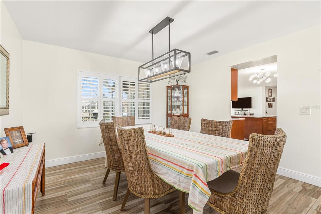 5 Cheyenne Court Palm Coast, FL 32137 - Photo 10 of 61 a view of a dining room with furniture window and wooden floor