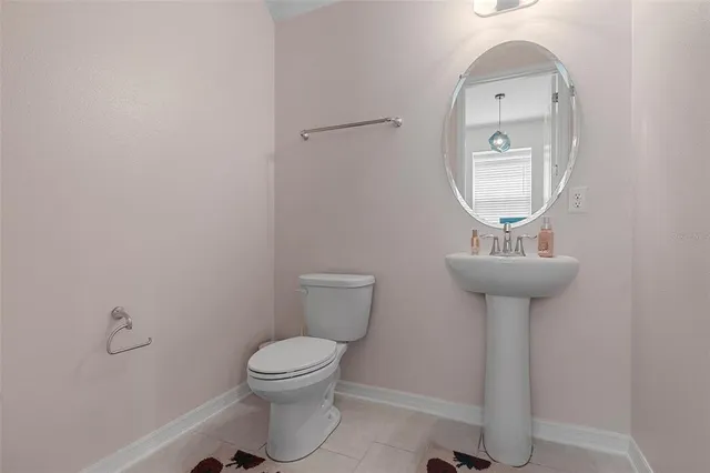 a bathroom with a sink toilet and a mirror