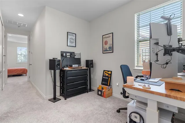 a view of a workspace with furniture and a window