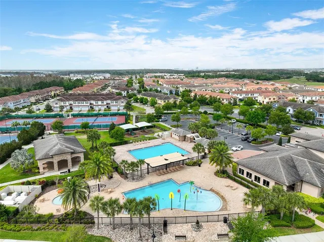 an aerial view of residential houses with yard