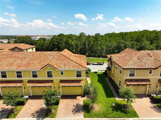 an aerial view of a building with an outdoor space and seating