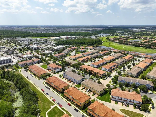 an aerial view of residential building with yard