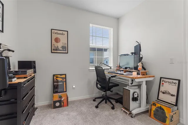 a view of a workspace with furniture and a window