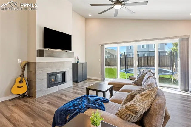 a living room with furniture a fireplace and a flat screen tv