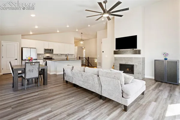 a living room with furniture a fireplace and a flat screen tv