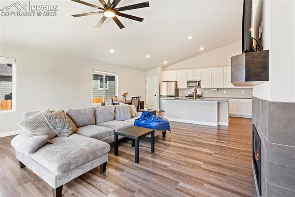 a living room with furniture and a wooden floor