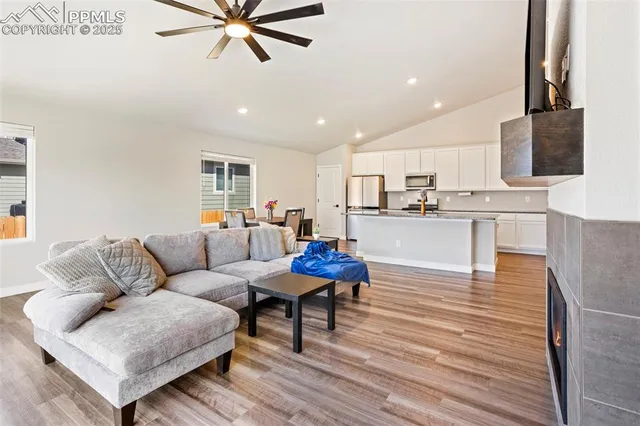 a living room with furniture and a wooden floor