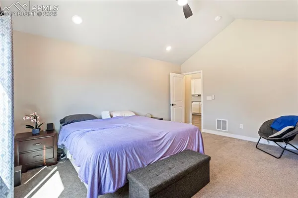 a spacious bedroom with a bed and furniture