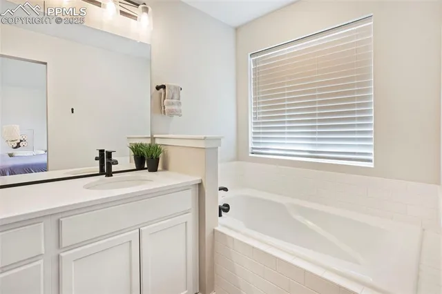 a bathroom with a bathtub a sink and a window