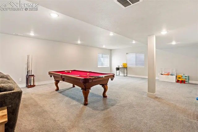 a room with furniture and air hockey table