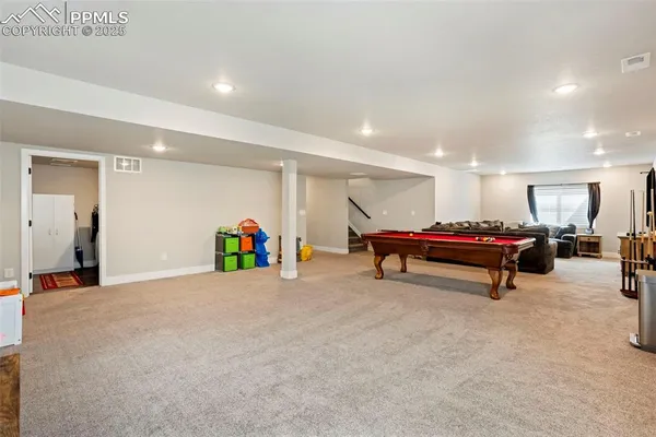 a room with furniture and air hockey table