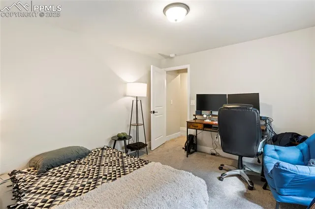 a bedroom with a workspace